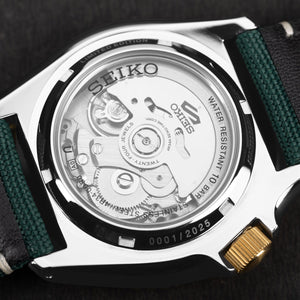 Transparent case back of the Seiko 5 Sports Forest Green Sunrise GMT, showcasing the automatic mechanical movement, Caliber 4R34